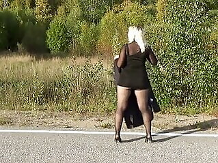 mature Walking on the road in a mini dress babe blonde
